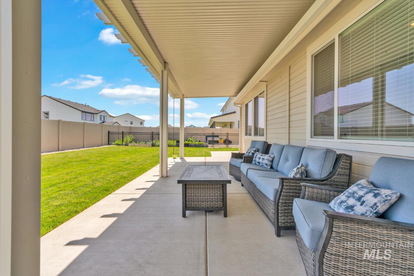 20430 Pitkin Way Caldwell, ID 83605 - Photo 15 of 23 Fenced backyard with outdoor lounge area and a patio area