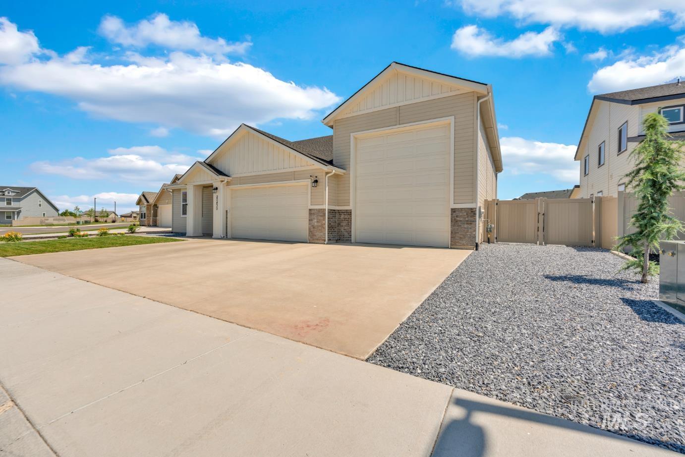 20430 Pitkin Way Caldwell, ID 83605 - Photo 22 of 23 View of front facade with a gate, a garage, and concrete driveway