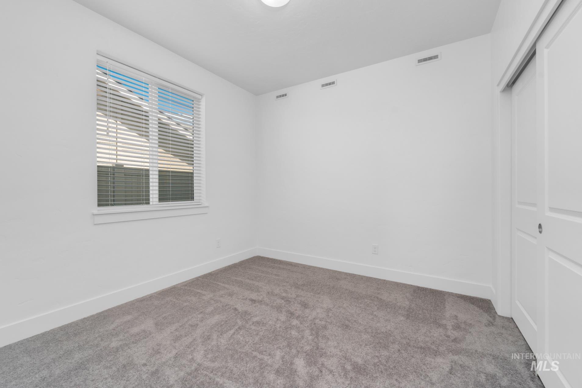 20430 Pitkin Way Caldwell, ID 83605 - Photo 9 of 23 Empty room with carpet floors and baseboards