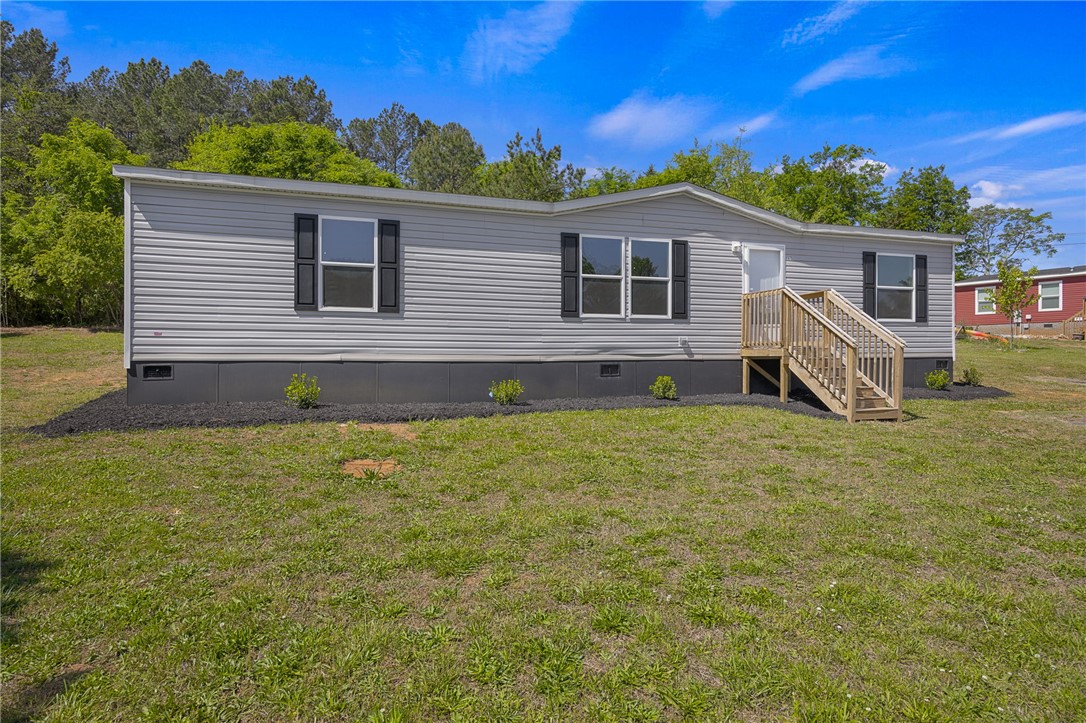 375 Griggs Road Six Mile, SC 29682 - Photo 2 of 36 This charming home offers a serene escape with its inviting facade and well-maintained surroundings.