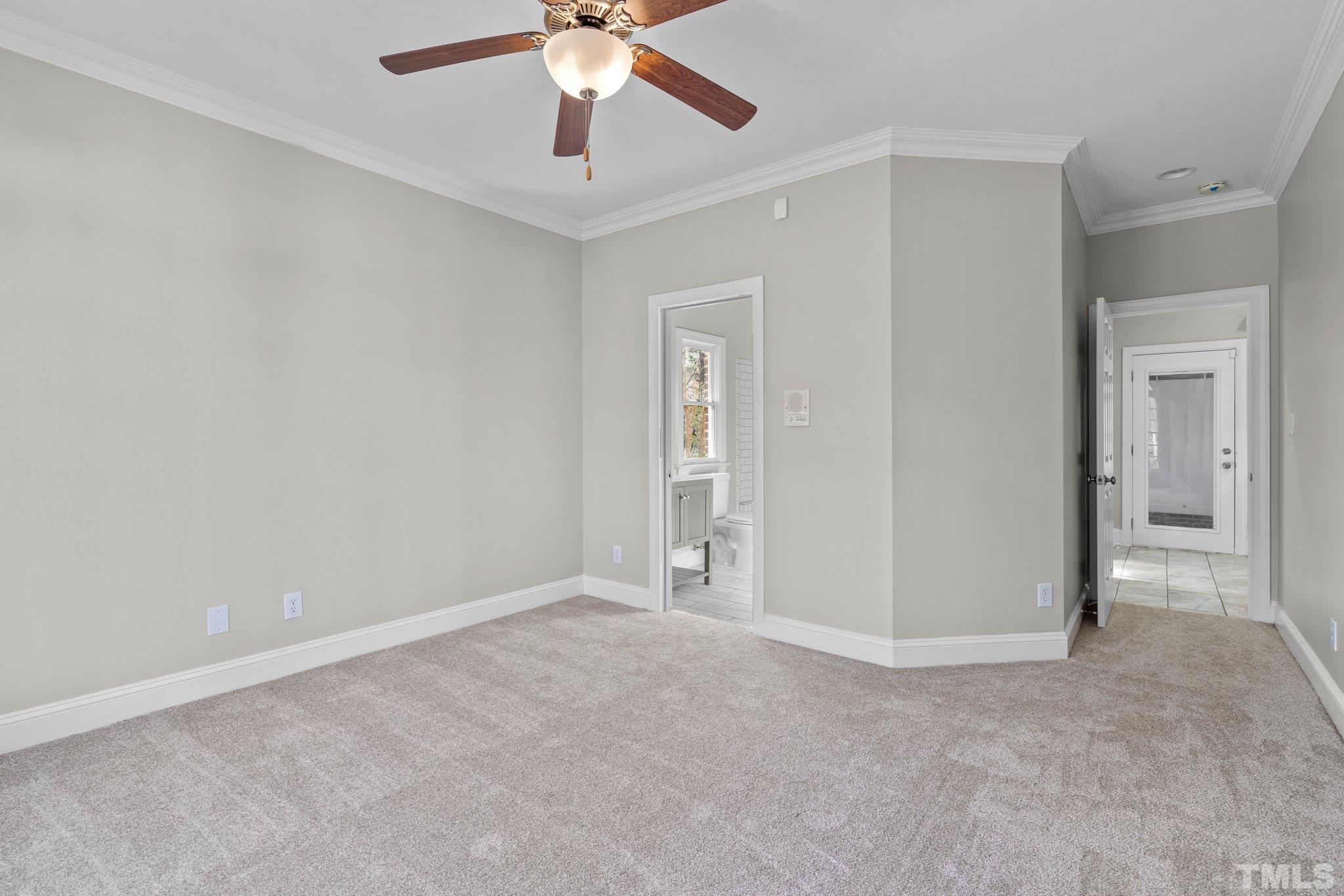 633 Pendleton Lake Road Raleigh, NC 27614 - Photo 13 of 56 an empty room with a chandelier fan and windows