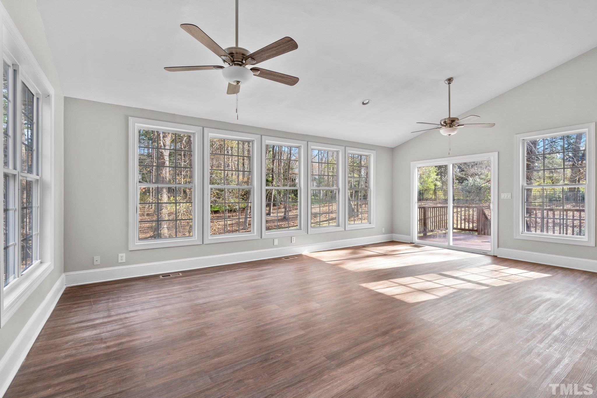 633 Pendleton Lake Road Raleigh, NC 27614 - Photo 16 of 56 a view of an empty room with wooden floor and a window