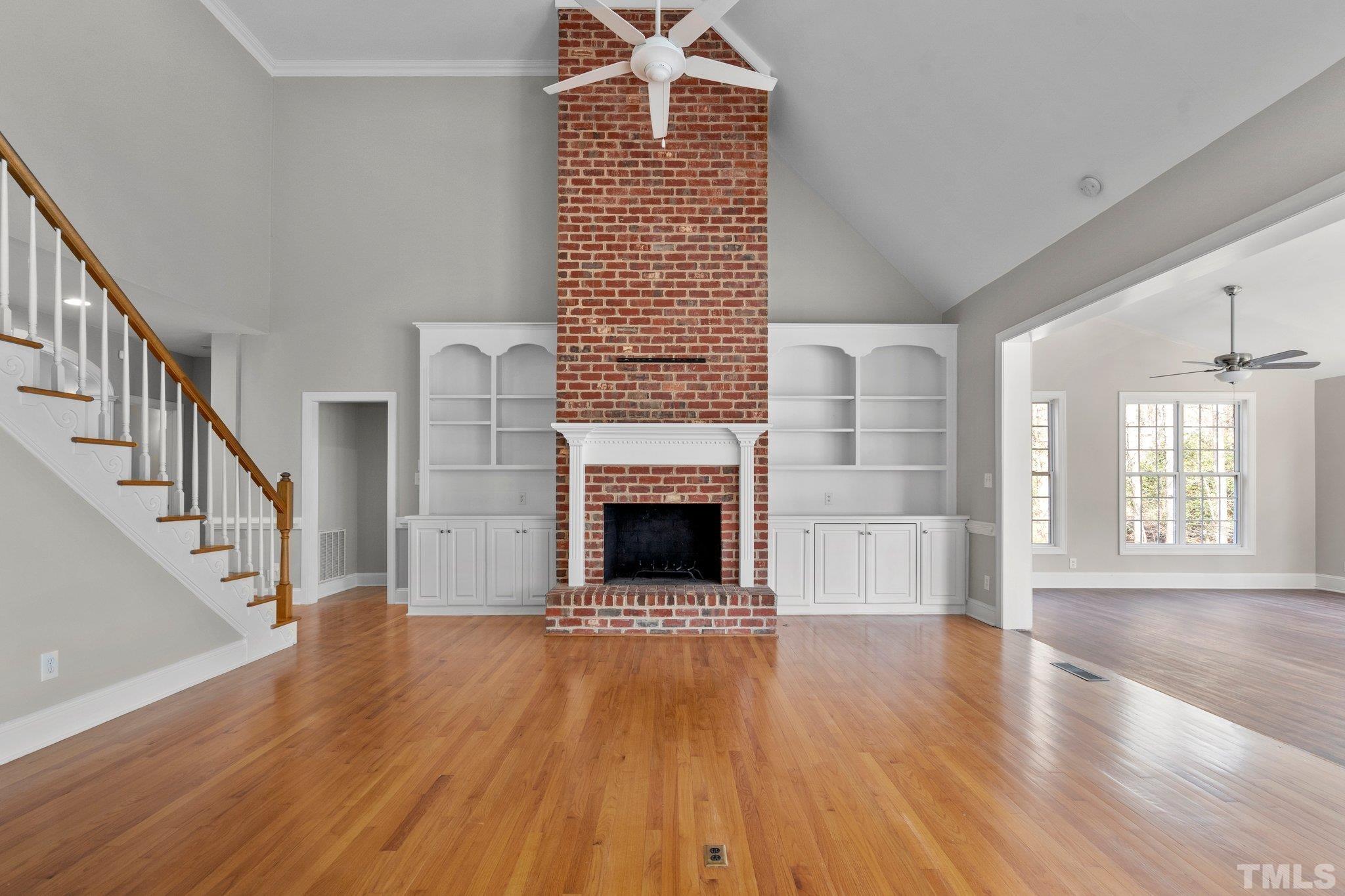 633 Pendleton Lake Road Raleigh, NC 27614 - Photo 18 of 56 a view of a livingroom with wooden floor fireplace and windows