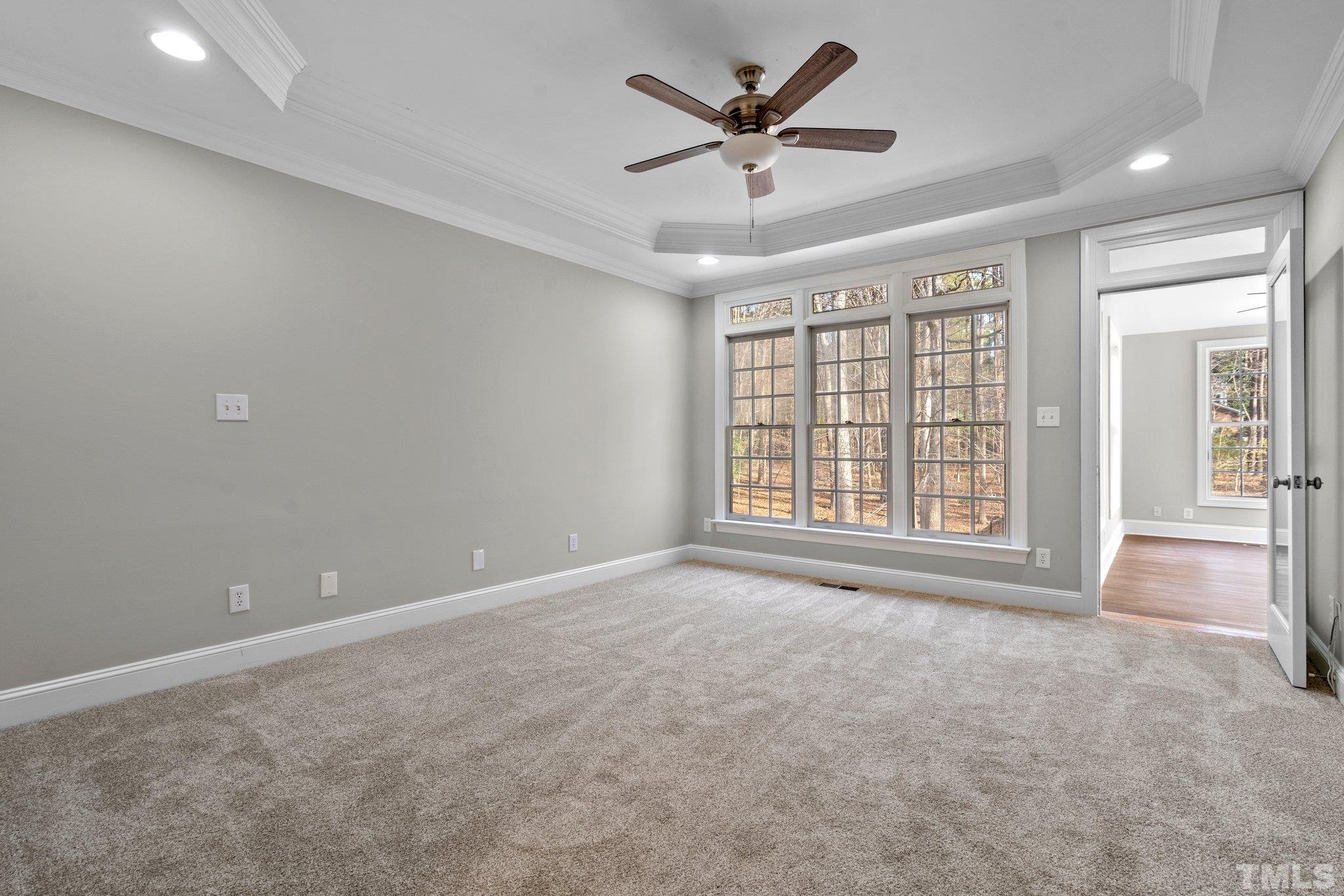 633 Pendleton Lake Road Raleigh, NC 27614 - Photo 19 of 56 an empty room with chandelier fan and windows