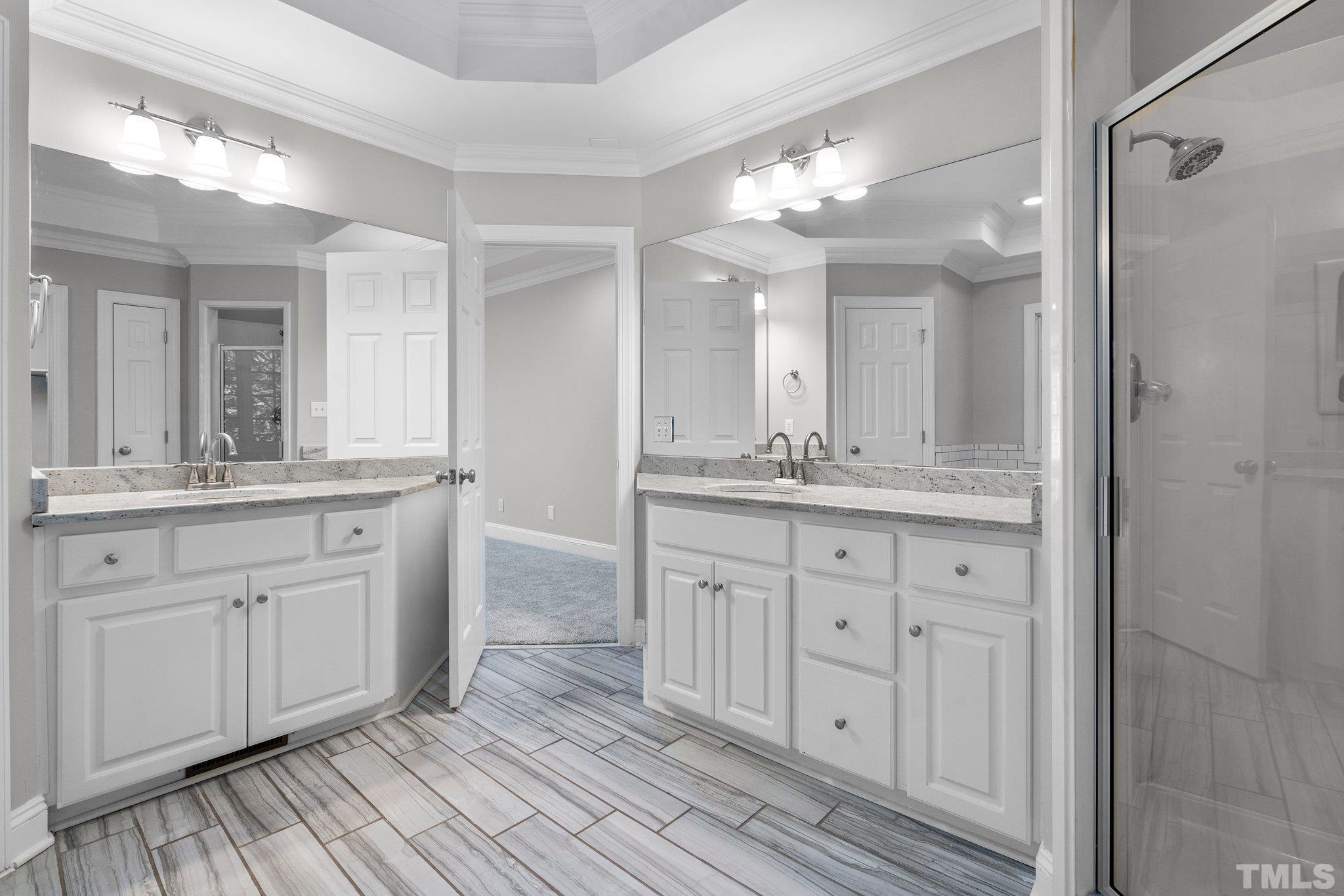 633 Pendleton Lake Road Raleigh, NC 27614 - Photo 21 of 56 a bathroom with a double vanity sink and a mirror