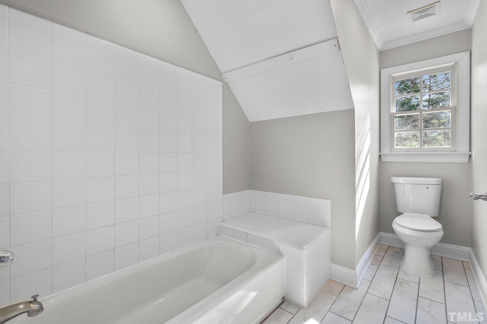 633 Pendleton Lake Road Raleigh, NC 27614 - Photo 28 of 56 a bathroom with a bathtub and a toilet