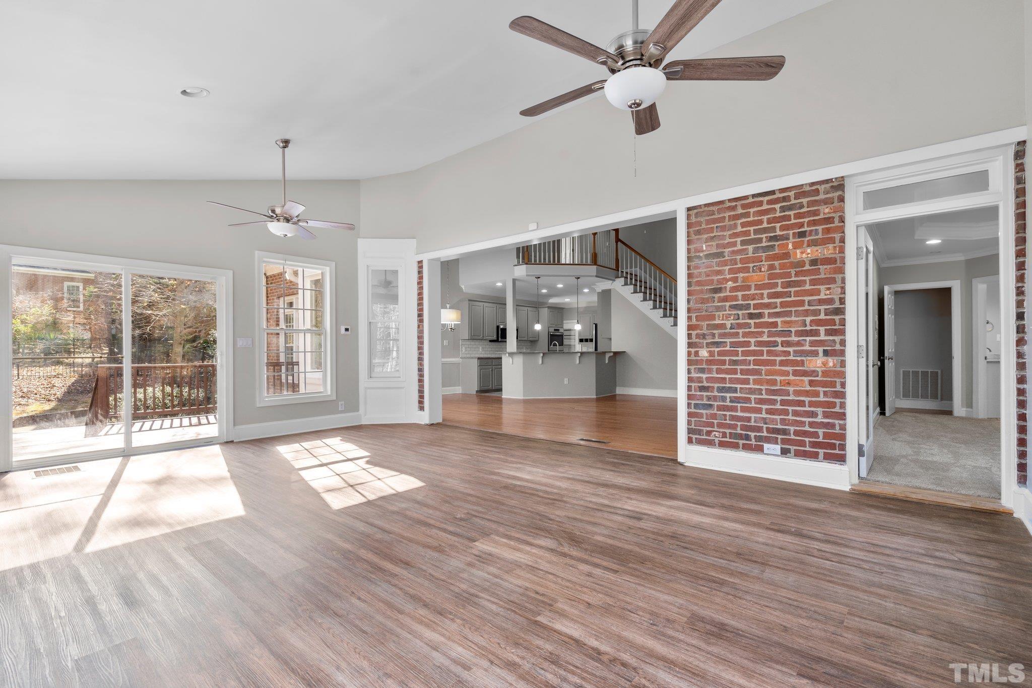 633 Pendleton Lake Road Raleigh, NC 27614 - Photo 32 of 56 a view of an empty room with wooden floor and a window