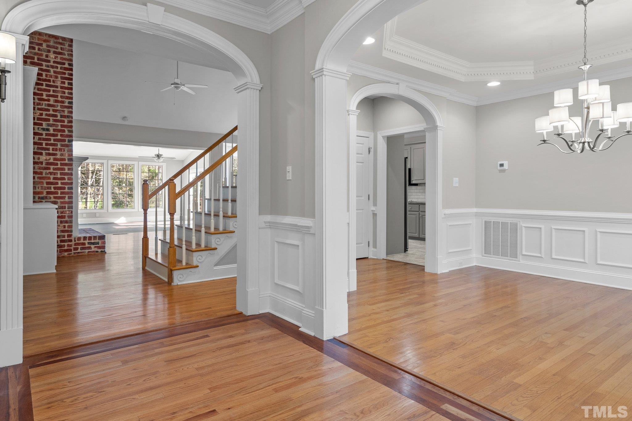 633 Pendleton Lake Road Raleigh, NC 27614 - Photo 37 of 56 a view of a hallway with wooden floor and chandelier