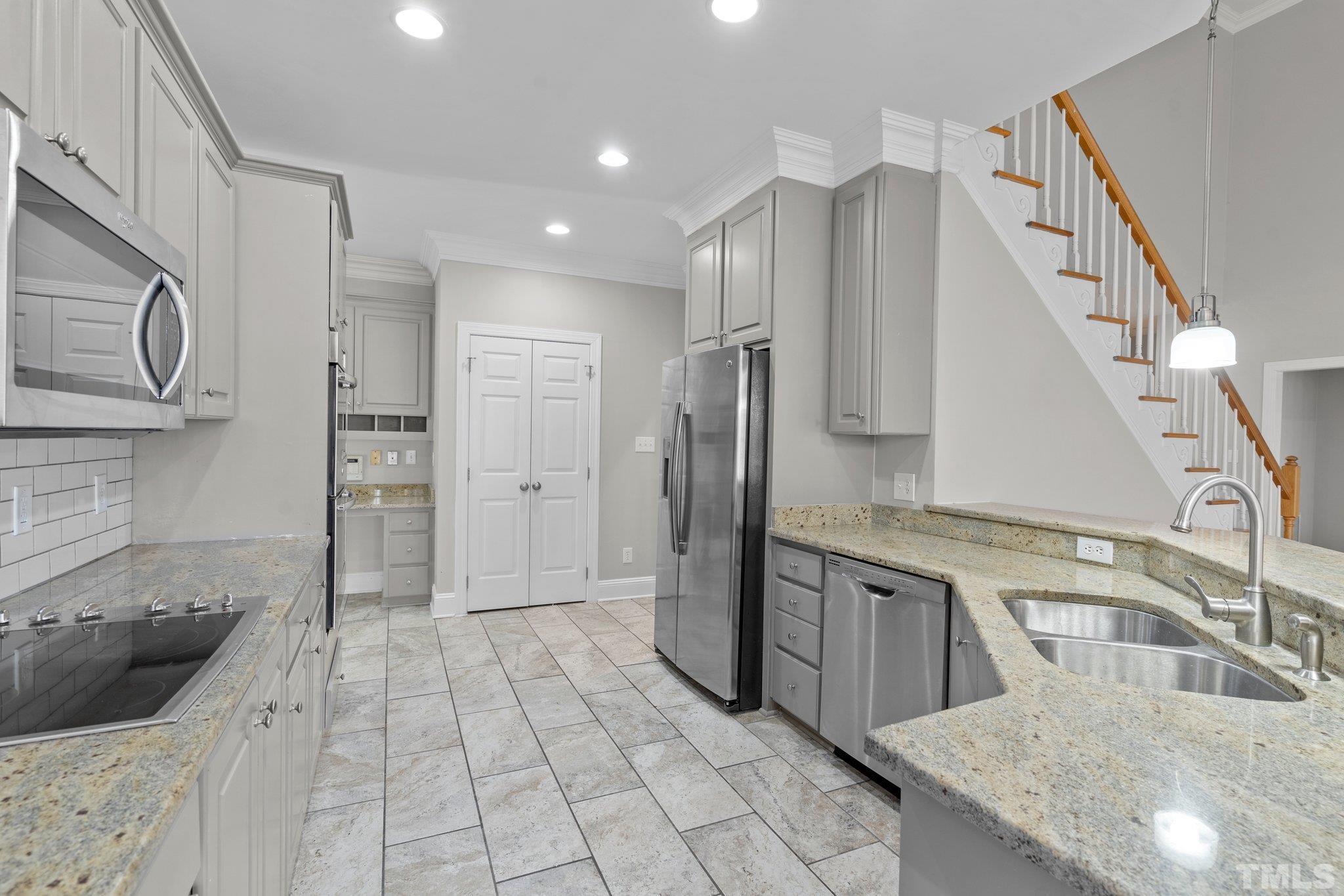 633 Pendleton Lake Road Raleigh, NC 27614 - Photo 9 of 56 a kitchen with stainless steel appliances granite countertop a refrigerator a sink and white cabinets