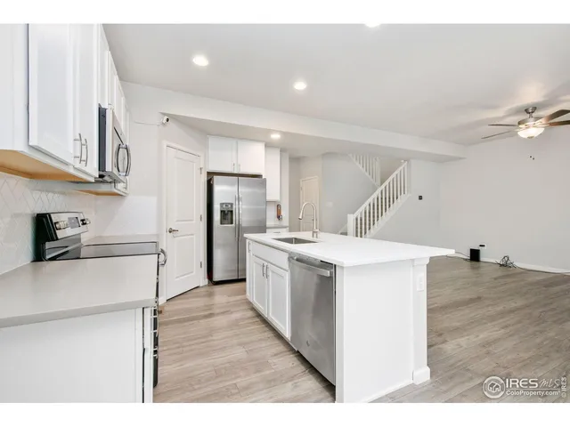 a kitchen with a stove a refrigerator and a sink