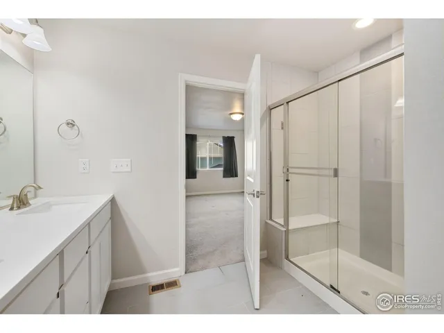 a bathroom with a shower and a sink