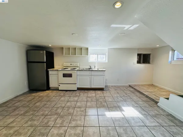 a kitchen with a cabinets and a stove top oven