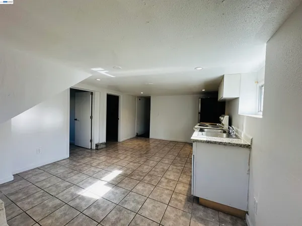 a view of a kitchen with a sink and a refrigerator