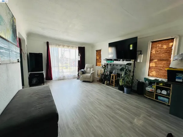 a bedroom with furniture a flat screen tv and a fireplace