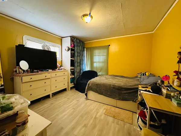 a bedroom with a bed and flat screen tv