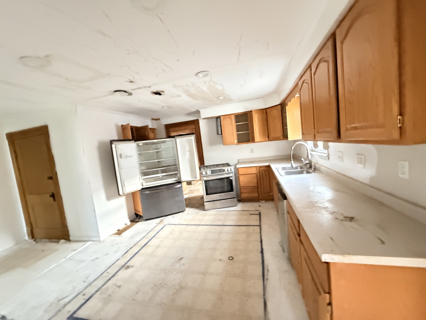 101 5th Street Carmi, IL 62821 - Photo 7 of 28 a kitchen with stainless steel appliances kitchen island granite countertop a sink and a refrigerator