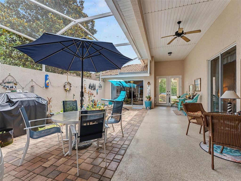8910 Jericho Road Weeki Wachee, FL 34613 - Photo 13 of 52 a view of a dining table and chairs under an umbrella in the patio
