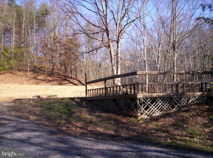 520 Packing Shed Road Berkeley Springs, WV 25411 - Photo 3 of 11 a view of a yard with wooden fence and trees