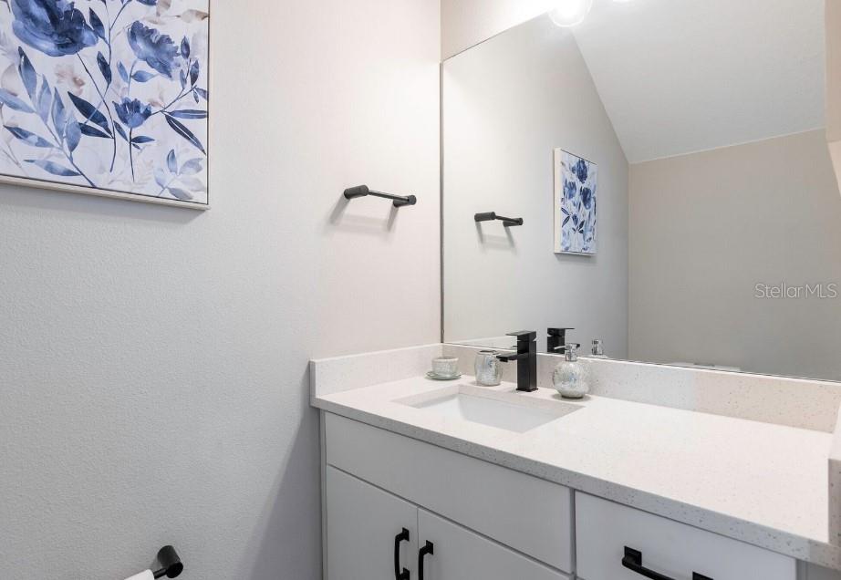 2116 Broome Street Kissimmee, FL 34743 - Photo 6 of 16 a bathroom with a sink and a mirror