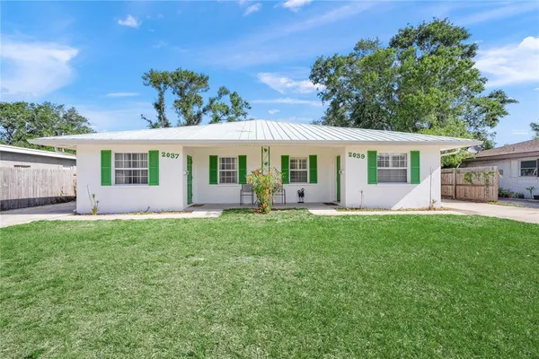 a view of a house with backyard porch and sitting area