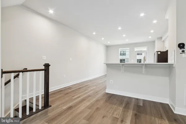 a view of a kitchen with wooden floor and stairs