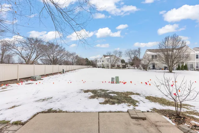 a white house with snow in front of it