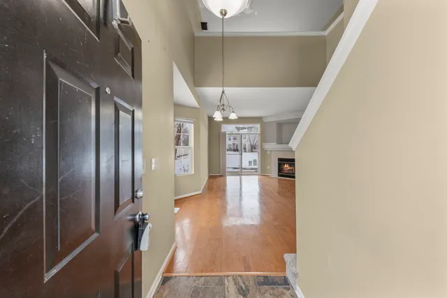 a view of a hallway view with wooden floor and staircase