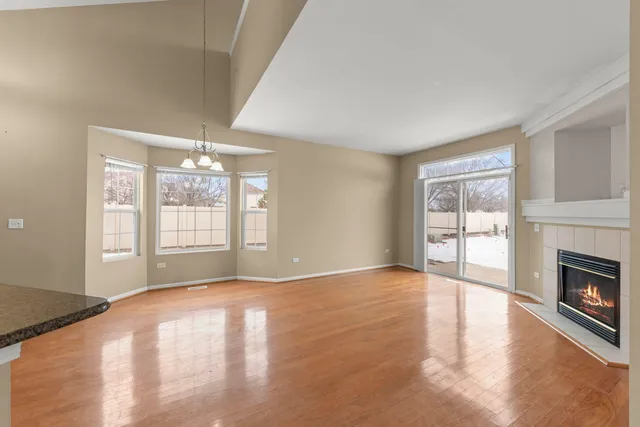 a view of an empty room with window and fire place