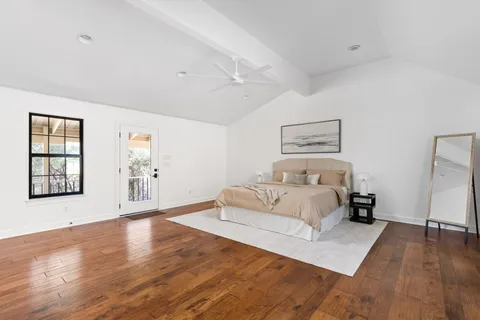 a bedroom with a bed and a large window