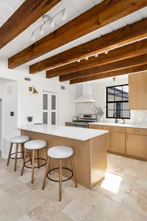a kitchen with a stove a table and chairs in it