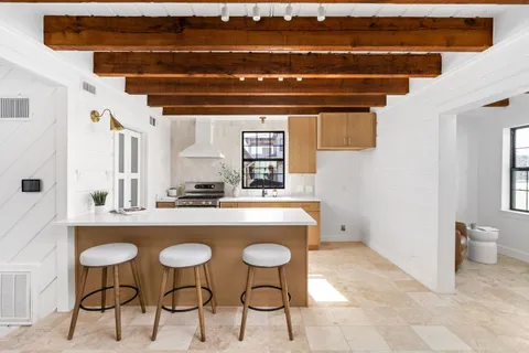 a view of dining room and kitchen with a sink