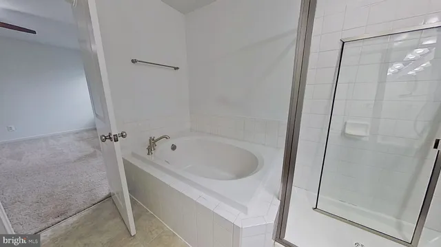 a bath tub sitting next to a shower