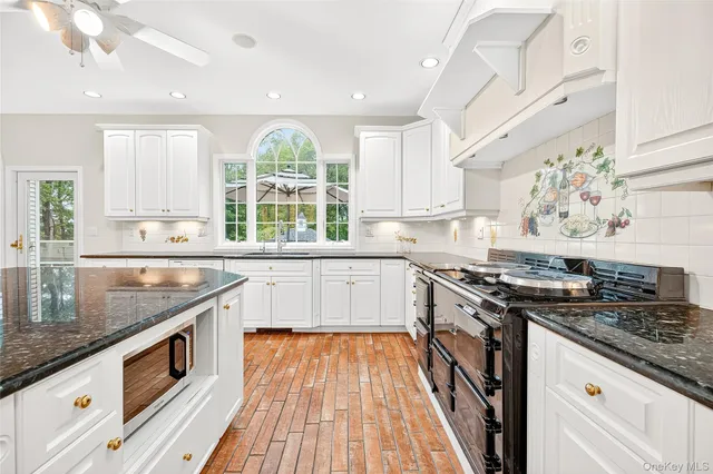 a kitchen with stainless steel appliances granite countertop a stove and a sink