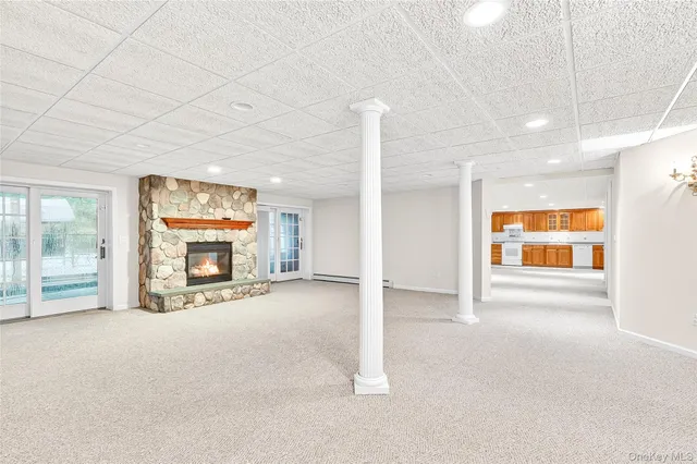 a view of an empty room with a fireplace and a window