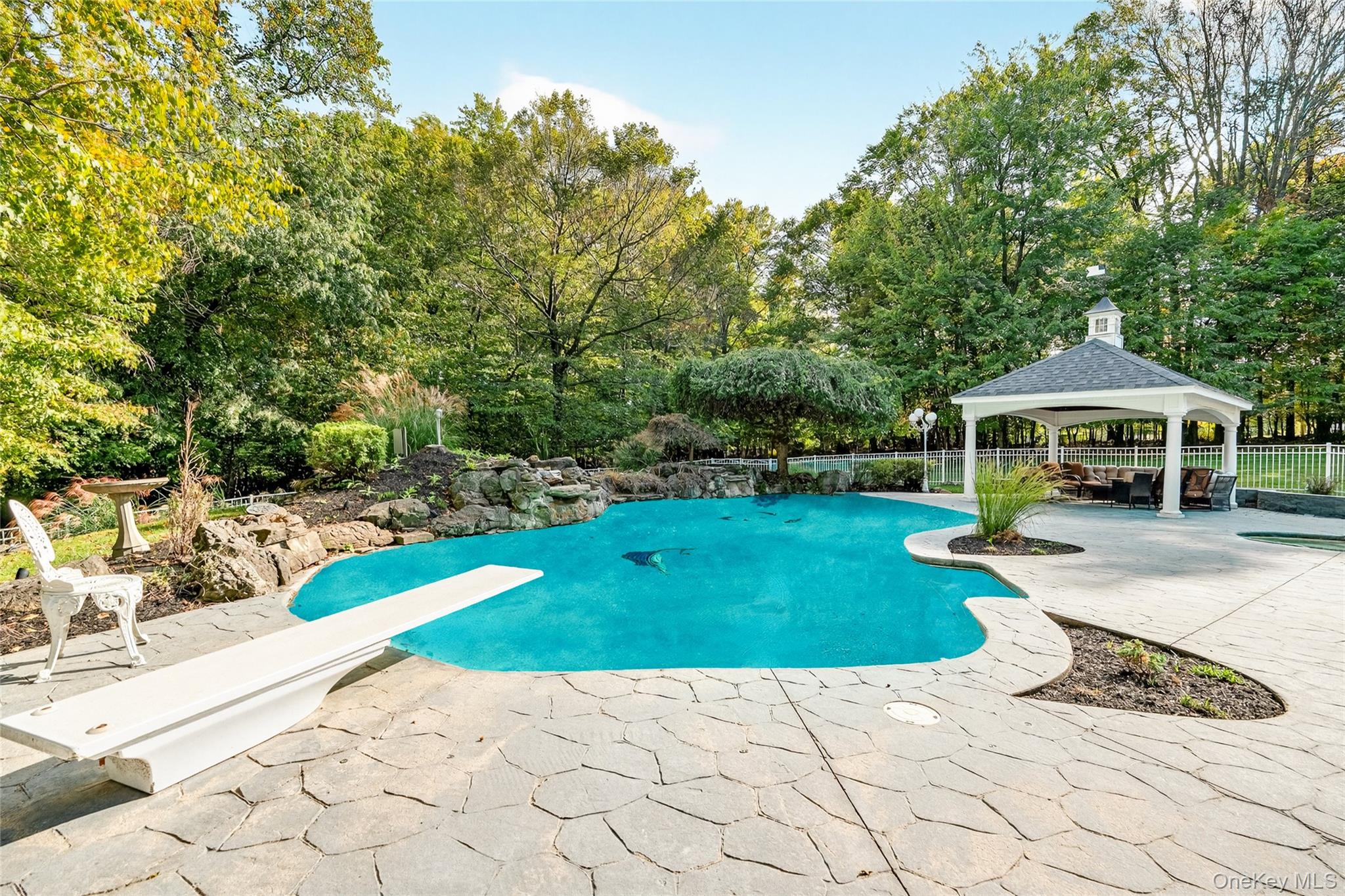 21 Bensons Point Court Stony Point, NY 10980 - Photo 45 of 50 a view of a patio with a table and chairs under an umbrella