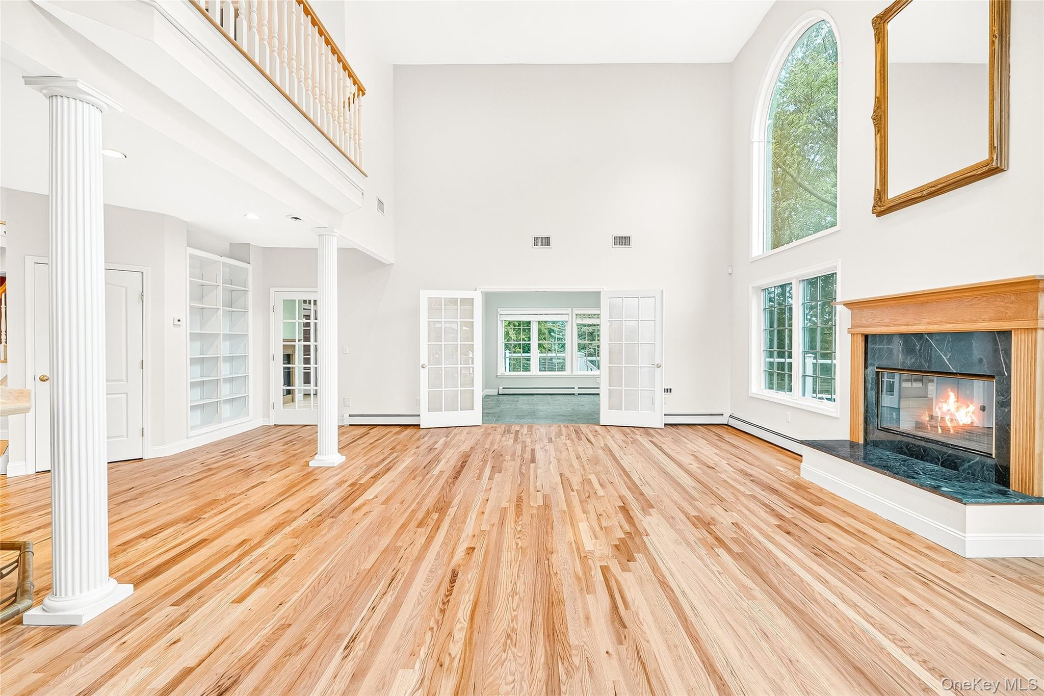 21 Bensons Point Court Stony Point, NY 10980 - Photo 10 of 50 a view of an empty room with wooden floor fireplace and a window