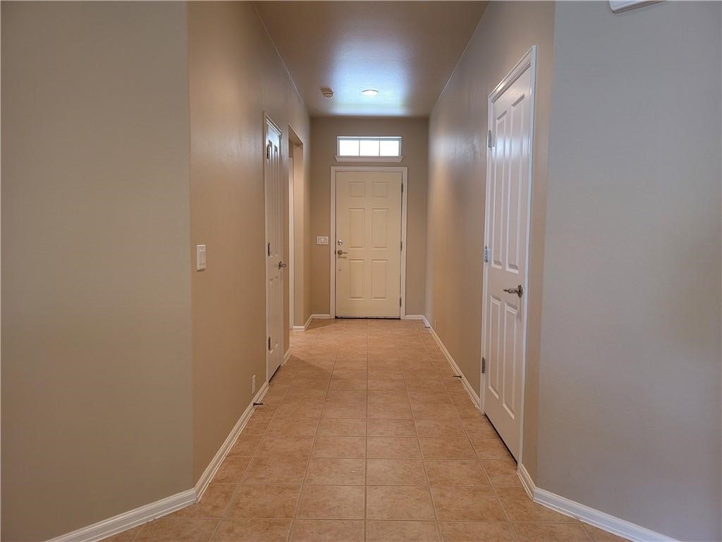 208 Hummingbird Lane Leander, TX 78641 - Photo 4 of 25 A well-lit corridor welcomes you home with durable tiled flooring.