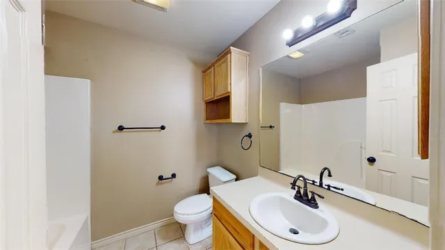 a bathroom with a sink toilet a mirror and vanity