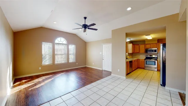 a view of wooden floor and a kitchen