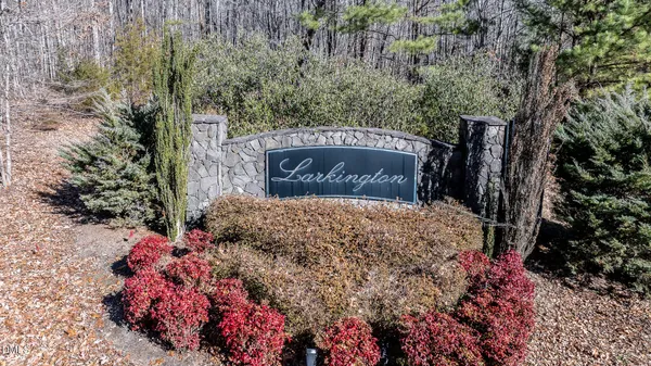 a sign that is sitting in front of a bunch of flowers