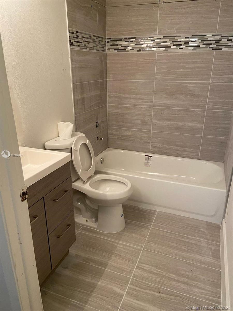 Welleby Sunrise, FL 33351 - Photo 5 of 9 a bathroom with a toilet a sink and shower