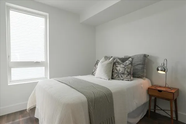 a bedroom with a bed and a window