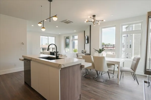 a view of a a dining room with furniture window and wooden floor