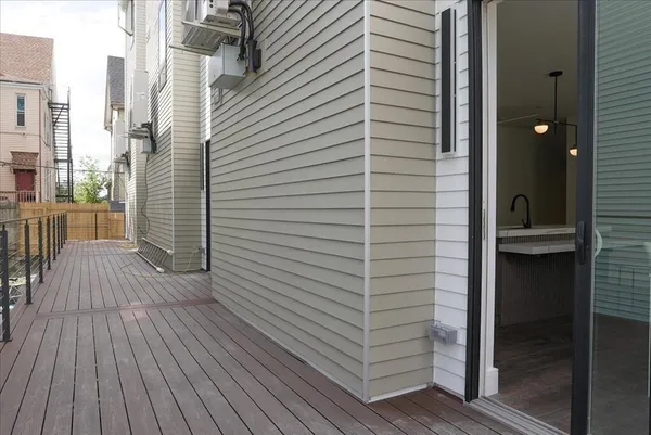 a view of a balcony with door and wooden floor