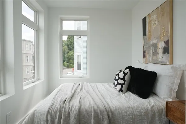 a bedroom with a bed and a window