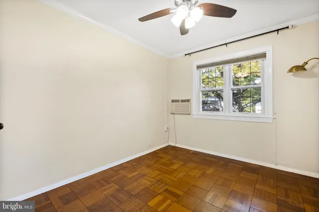 a view of a big room with wooden floor and windows in a room
