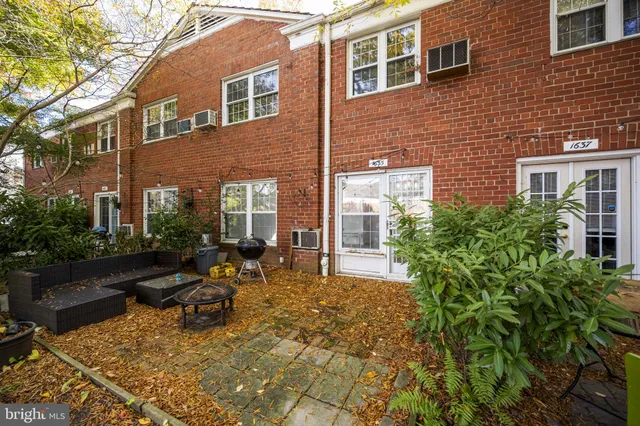 a view of backyard of house with outdoor seating