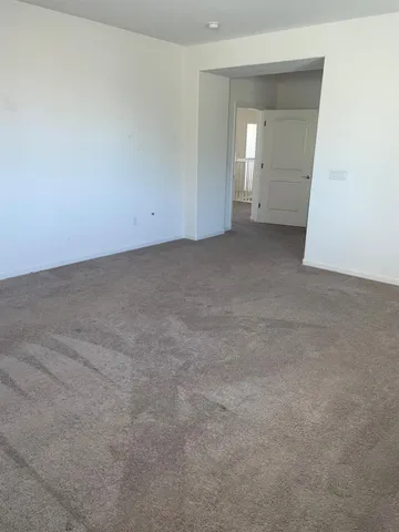 an empty room with an entrance to other room