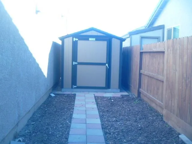 a view of a room with wooden floor and windows