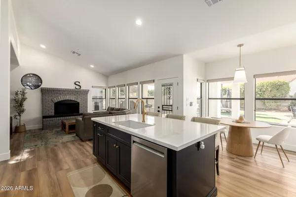 a kitchen with a sink a refrigerator and a stove top oven